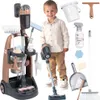 A young boy is standing next to a toy cleaning cart and various cleaning accessories. Produktbild-Vorschau