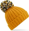 A close-up shot of a knitted beanie with a pom-pom. Produktbild-Vorschau