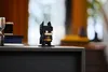 A small Lego Batman figure stands on a dark surface, with blurred background elements suggesting an indoor setting. Anteprima dell’immagine prodotto