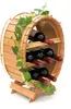 A wooden wine rack shaped like a barrel, holding six bottles of red wine, decorated with artificial ivy. Náhled obrázku produktu