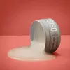 A container of hair gel is tipped over, with the gel spilling out onto a pink surface. Anteprima dell’immagine prodotto