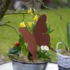 A close-up of a garden decoration with a butterfly stake in a pot of spring flowers. Produktbild-Vorschau