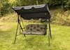 A garden swing set with a green cushion and a black canopy, set on a grassy lawn with trees in the background. Produktbild-Vorschau