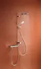 A modern shower system with water flowing from the showerhead, mounted on an orange-brown wall. Podgląd zdjęcia produktu