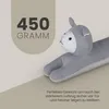 A stuffed animal shaped like a cat is shown lying down, with text overlays indicating its weight and function. Náhľad obrázku produktu