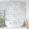 A modern bathroom with a white bathtub and a white shower curtain with a square pattern. Náhľad obrázku produktu