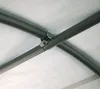 Close-up of the metal frame and white fabric of a shelter. Produktbild-Vorschau