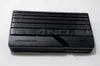 A black electronic device with horizontal lines on its top surface, placed on a white background. Produktbild-Vorschau