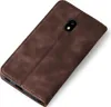 A brown leather flip case for a smartphone, shown from a diagonal top-down view against a white background. Produktbild-Vorschau