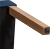 A close-up view of a wooden chair leg attached to a blue upholstered seat. Produktbild-Vorschau