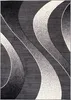 A close-up, top-down view of a modern rug with abstract wavy patterns in shades of gray, black, and white. Náhľad obrázku produktu