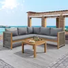 A sectional outdoor sofa and coffee table set on a patio overlooking the ocean. Podgląd zdjęcia produktu