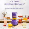 A purple electric juicer is shown on a countertop with glasses of juice and fruit in the background. Podgląd zdjęcia produktu