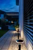 A pathway illuminated by solar lamps leads to a modern house with blinds at dusk. Produktbild-Vorschau