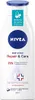 A white bottle of Nivea body lotion with blue accents and text. Voir les images du produit