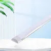 A white LED panel light is displayed diagonally on a white surface with a blurred background of vertical lines and a light blue sky. Voir les images du produit