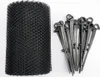 A roll of black mesh netting and a bundle of black plastic stakes on a white background. Podgląd zdjęcia produktu