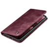 A burgundy flip case for a smartphone is shown from a diagonal angle, with the phone partially visible inside. Produktbild-Vorschau