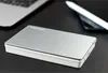 A silver Toshiba external hard drive is placed on a black surface, with a laptop and a stylus pen in the background. Produktbild-Vorschau