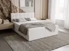 A bedroom setting with a white upholstered bed as the main focus, styled with bedding and a rug. Náhled obrázku produktu