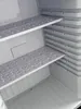 Interior view of a mini-refrigerator with shelves. Produktbild-Vorschau