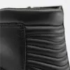 A close-up view of the top section of a black leather boot, showing stitching and quilted detailing. Podgląd zdjęcia produktu