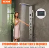 A woman is using a modern shower panel system in a bathroom. Anteprima dell’immagine prodotto
