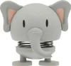 A close-up studio shot of a grey elephant bobblehead toy with pink inner ears, standing on a white background. Produktbild-Vorschau
