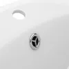 A close-up view of a white ceramic sink with a chrome drain and overflow hole. Podgląd zdjęcia produktu