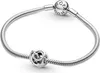 A silver Pandora bracelet with two charms on a white background. Podgląd zdjęcia produktu