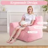 A woman sits on a pink beanbag chair, holding a pillow. The chair is labeled with text indicating ergonomic support. Náhled obrázku produktu