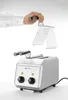 A hand holding a toaster accessory above a toaster. Anteprima dell’immagine prodotto
