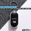 A black and silver key finder device with a keyring, placed on a textured surface and a white background. Text overlays describe its features. Produktbild-Vorschau