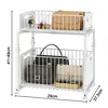 A white two-tier storage rack with handbags and keys on it. Voir les images du produit