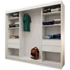 A white sliding door wardrobe with shelves and drawers, containing folded clothes and a green t-shirt hanging on a rail. A brown backpack is on the floor. Produktbild-Vorschau
