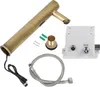 A collection of parts for a faucet, including the faucet body, a control box, hoses, and mounting hardware, laid out on a white background. Podgląd zdjęcia produktu
