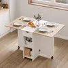 A drop-leaf dining table with storage is set for a meal in a kitchen. Voir les images du produit