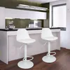 A modern kitchen with a breakfast bar and two white bar stools. Produktbild-Vorschau