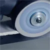 A grinding wheel is shown in close-up, cutting into a flat material. Anteprima dell’immagine prodotto