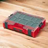 A red and clear plastic organizer box with multiple compartments is placed on a wooden surface. Anteprima dell’immagine prodotto