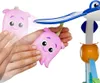 Hands holding a pink octopus toy that is part of a baby walker. Produktbild-Vorschau