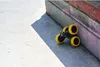 A toy car is positioned on a concrete surface next to a wall. Produktbild-Vorschau