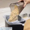 A hand is emptying a dustbin into a trash can lined with a plastic bag. Anteprima dell’immagine prodotto