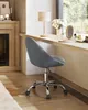 A gray office chair in front of a window with a desk. Náhled obrázku produktu