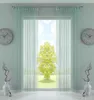 A room interior with a window covered by sheer mint-colored curtains, revealing a bright outdoor scene with a tree. Produktbild-Vorschau