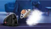 A person is using a steam iron with a separate water tank, producing a large amount of steam. Náhľad obrázku produktu