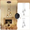 A living room with a fireplace and a coffee table, and diagrams of a pendant light. Voir les images du produit