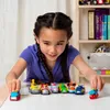 A young girl is playing with toy cars on a table. Anteprima dell’immagine prodotto