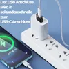 A smartphone is being charged by a power adapter plugged into a power strip. The phone screen shows the charging status. Produktbild-Vorschau