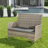 A rattan bench with a gray cushion sits on a green lawn next to a swimming pool. Produktbild-Vorschau